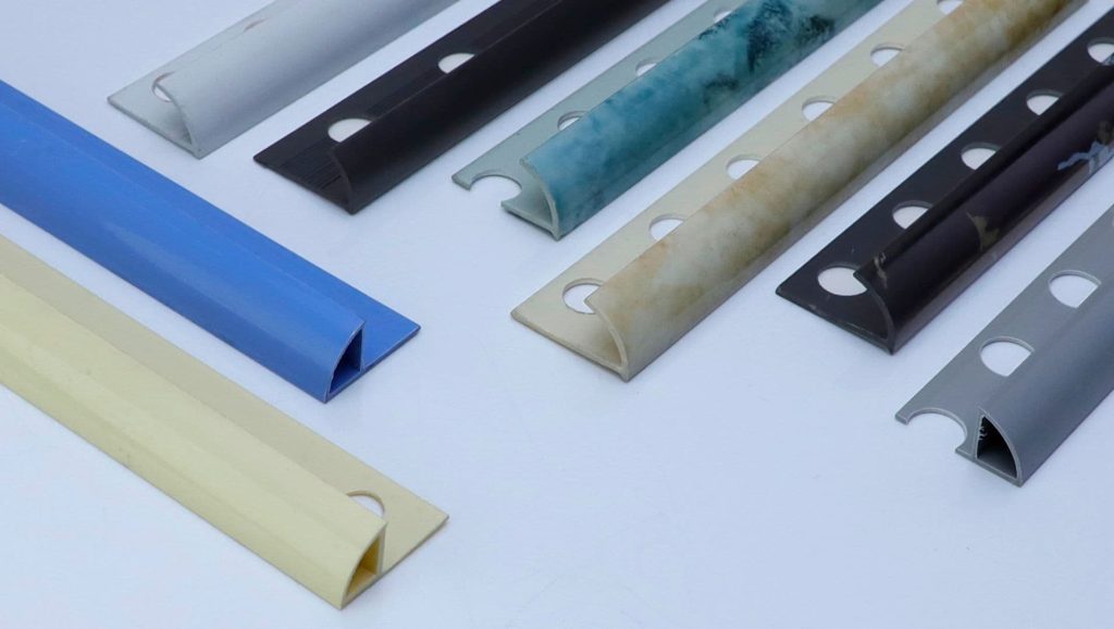 A collection of various pvc tile trims on a white surface