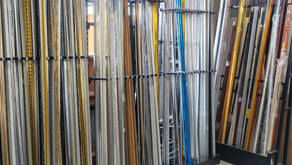 Various types of tile trims displayed in a showroom