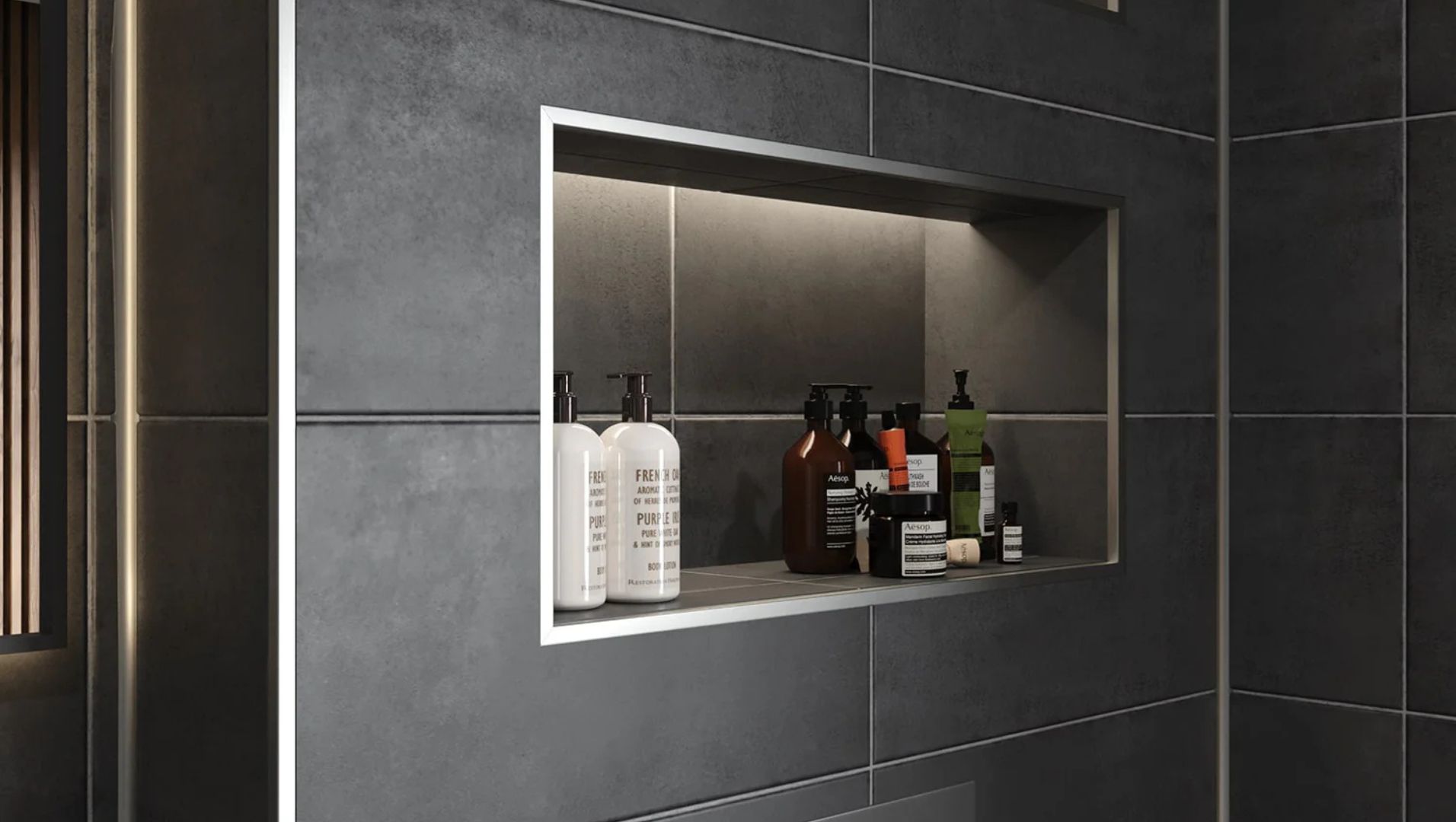 Close-up of metal tile trims installed in a modern bathroom setting.