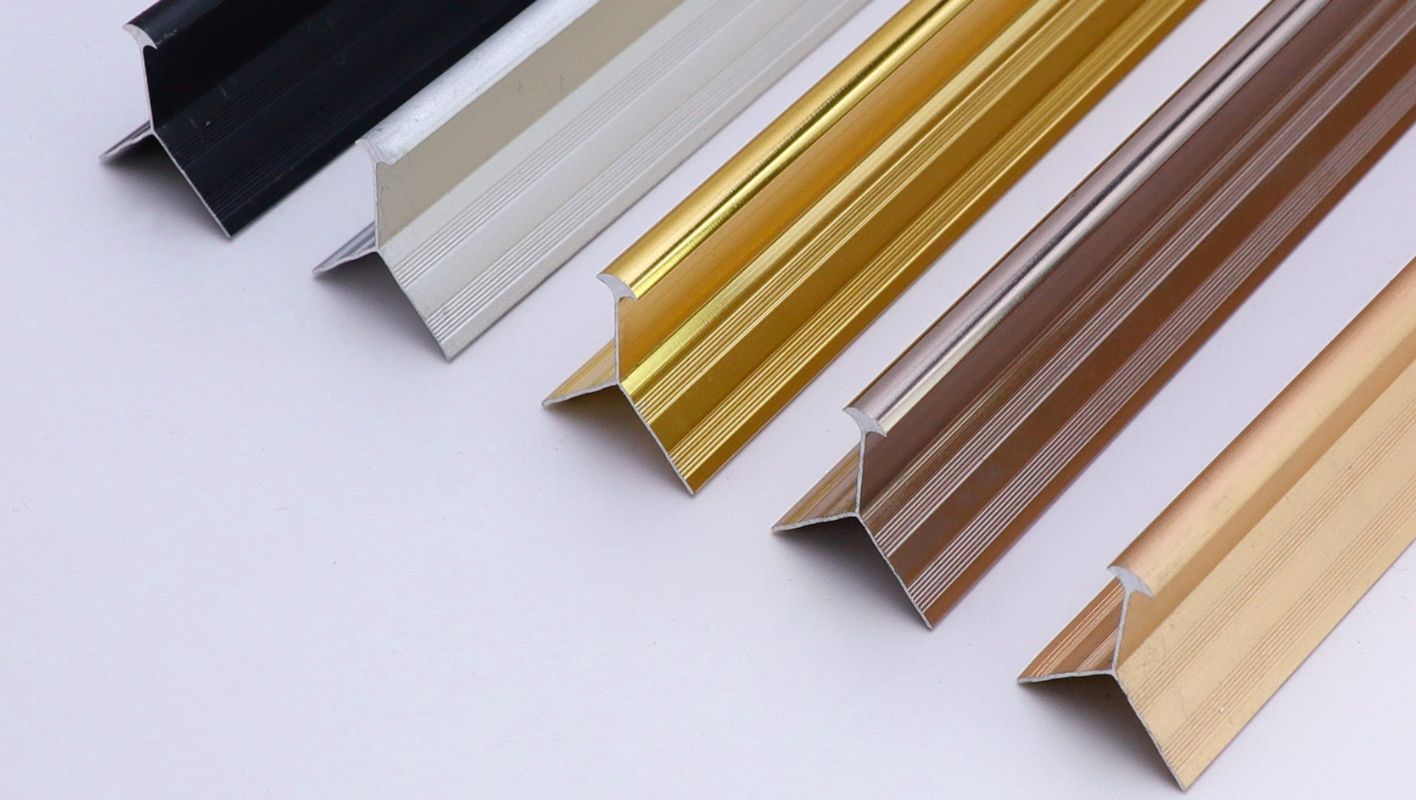 Anodised aluminium profiles in various colors against a modern architectural backdrop.