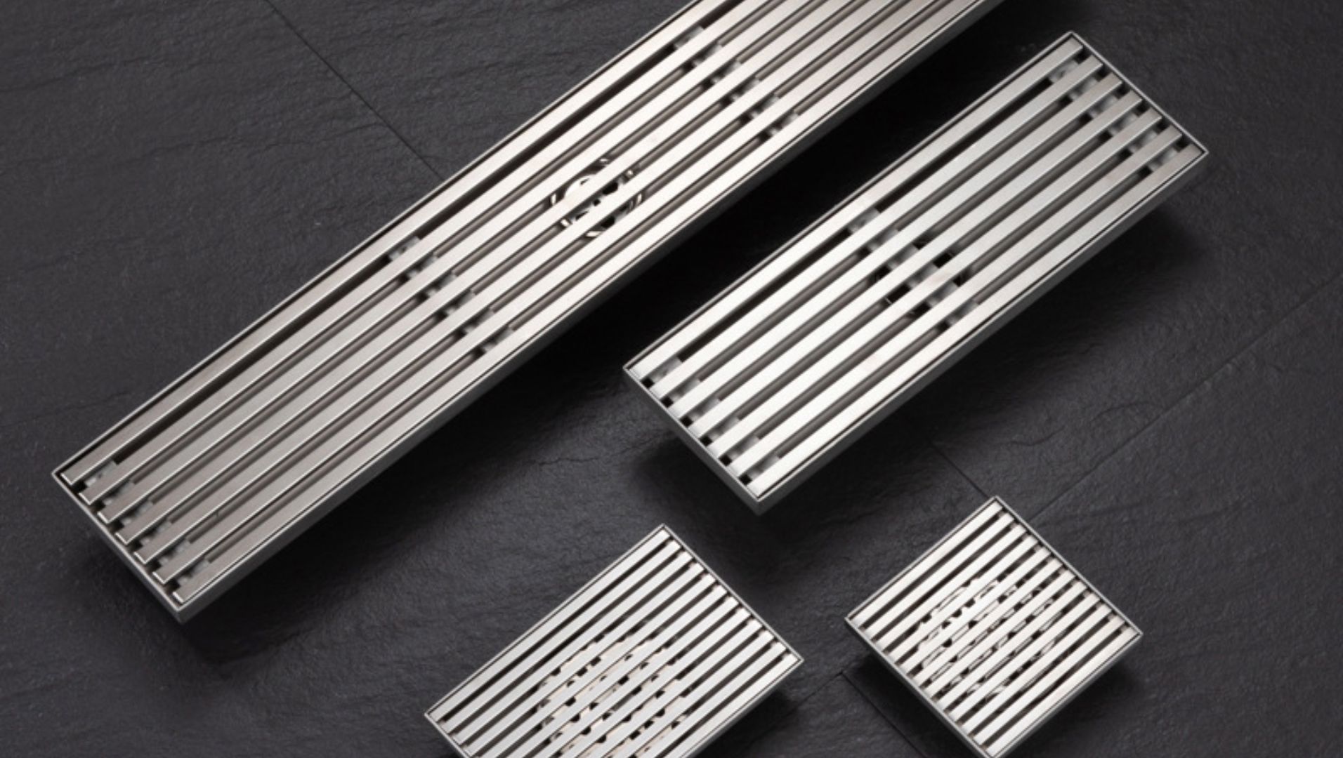 Various types of floor drains displayed on a surface