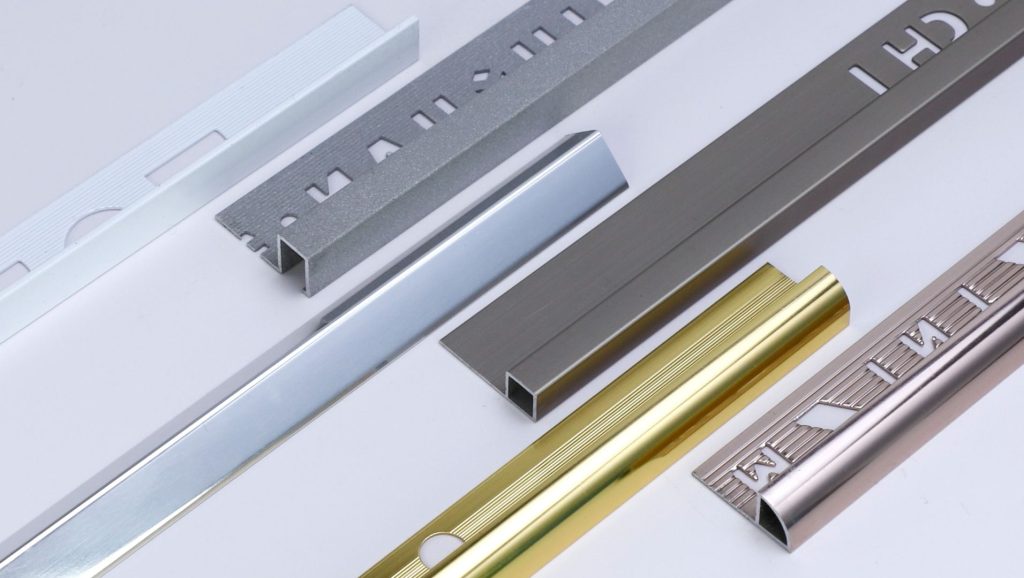 Close-up of aluminum tile trim against a plain background