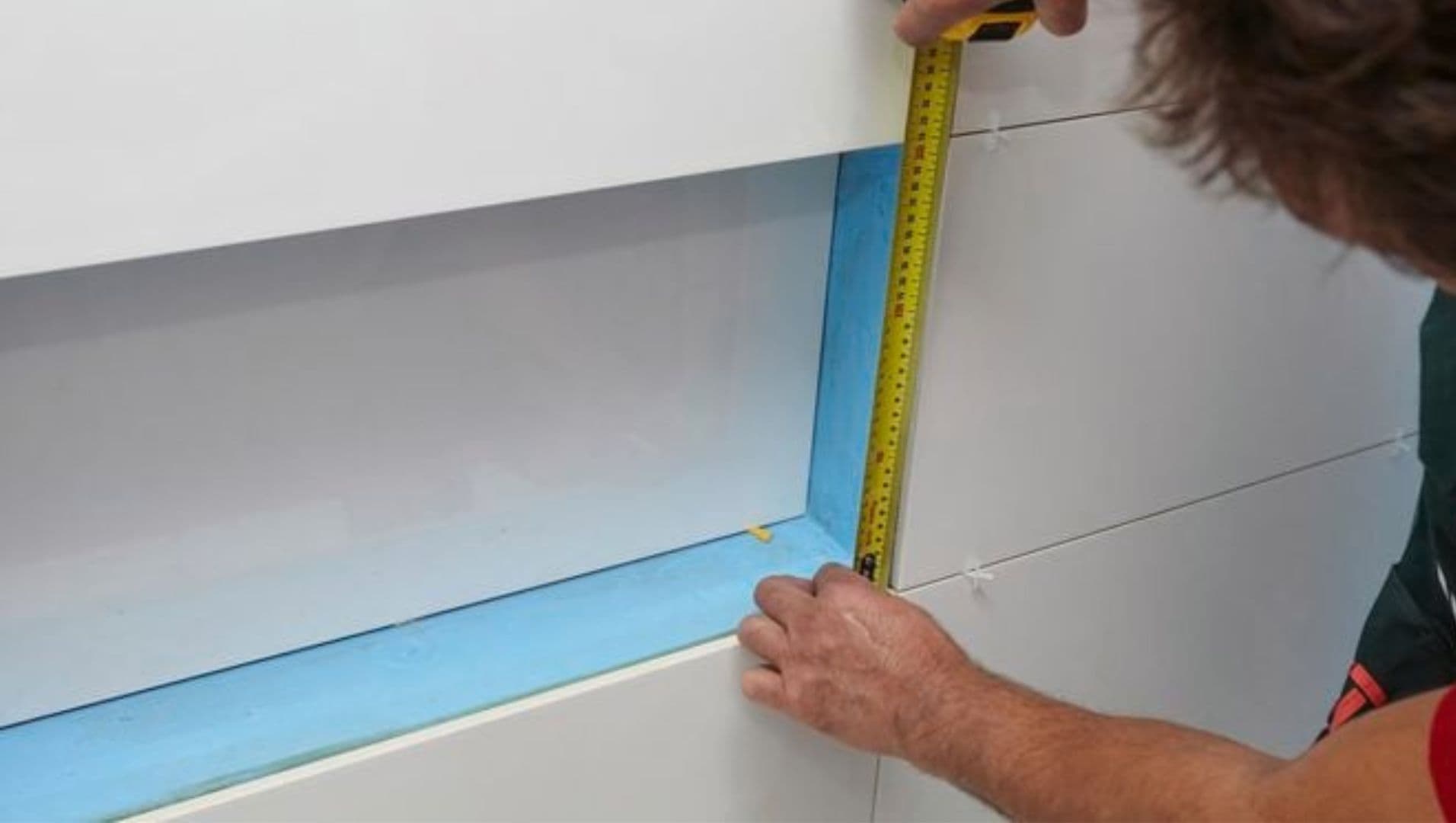 A person installing PVC tile trim