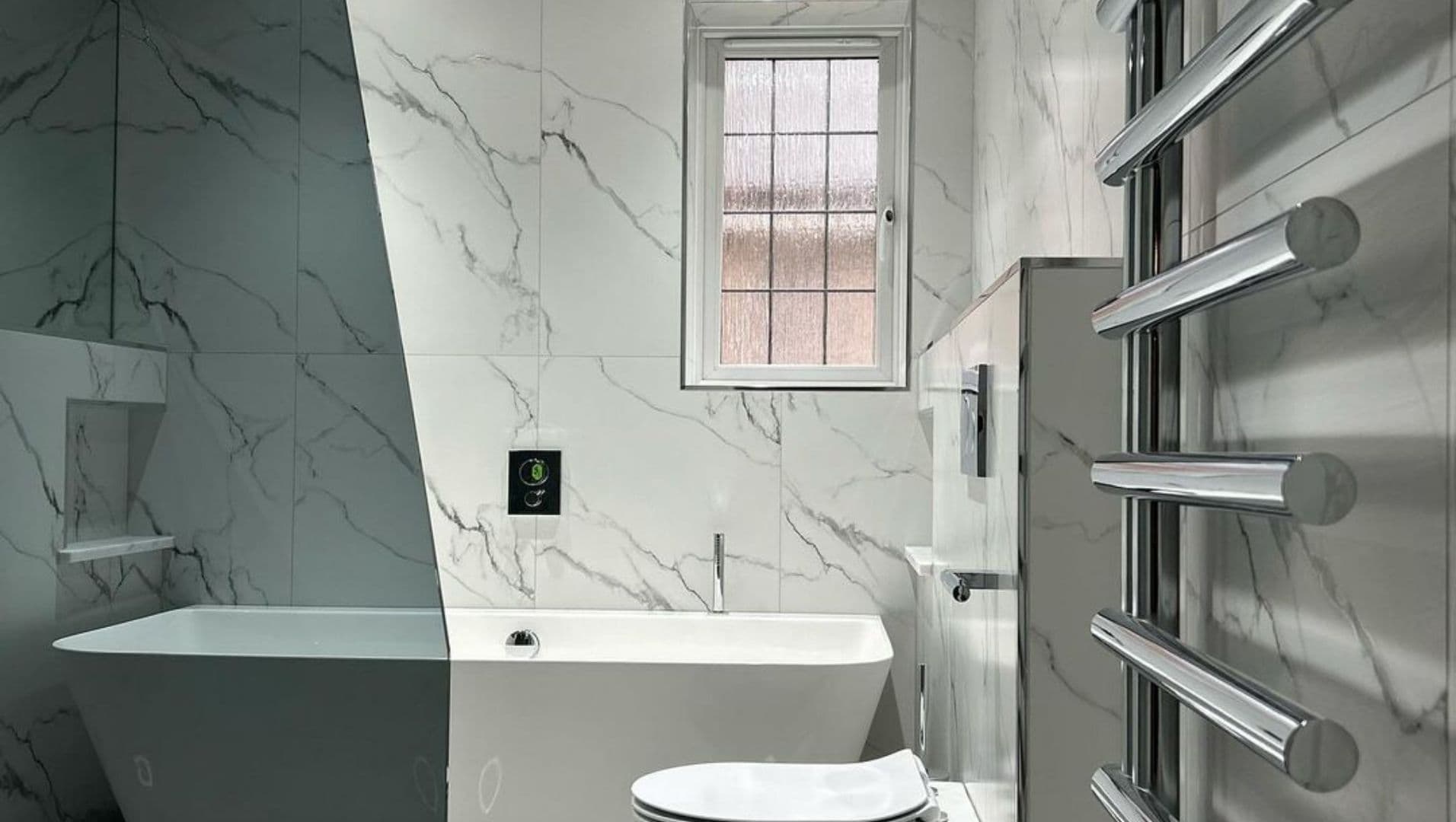 A modern bathroom with polished ceramic tiles and sleek trim.