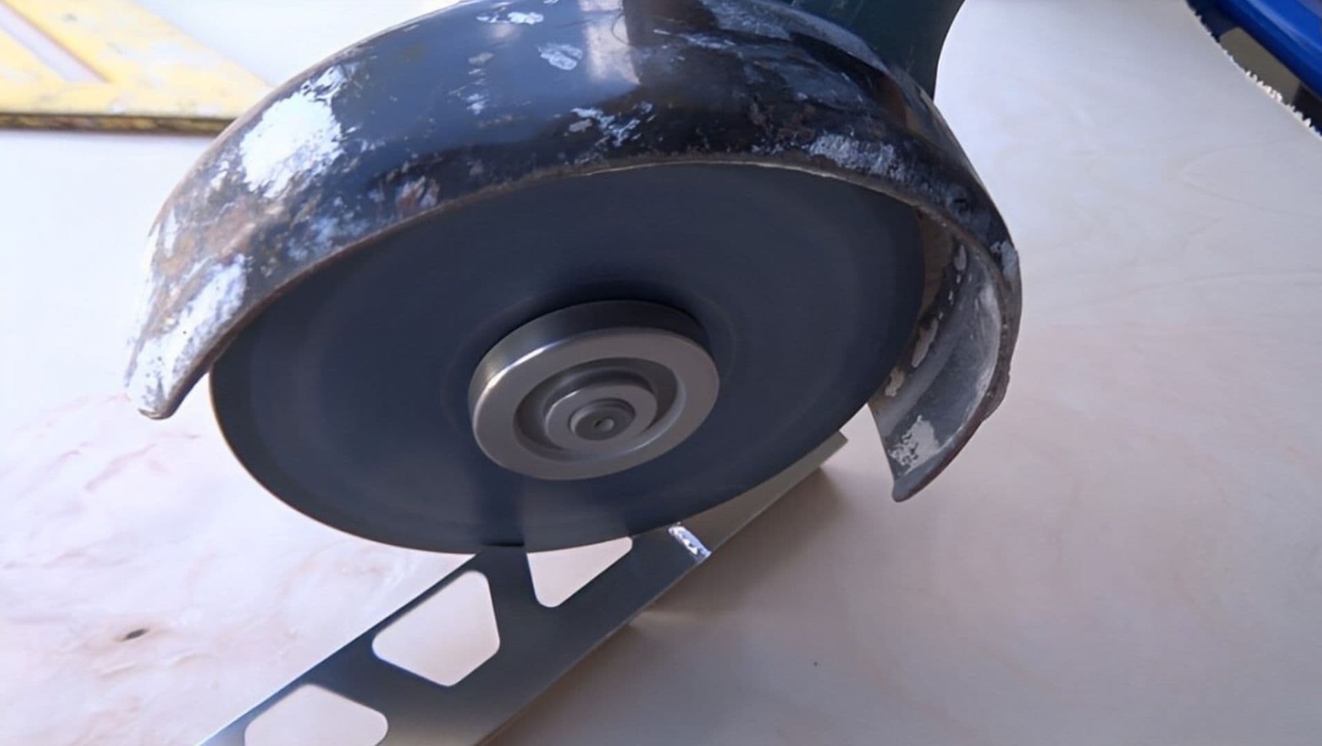 Person using a miter saw to cut metal tile trim