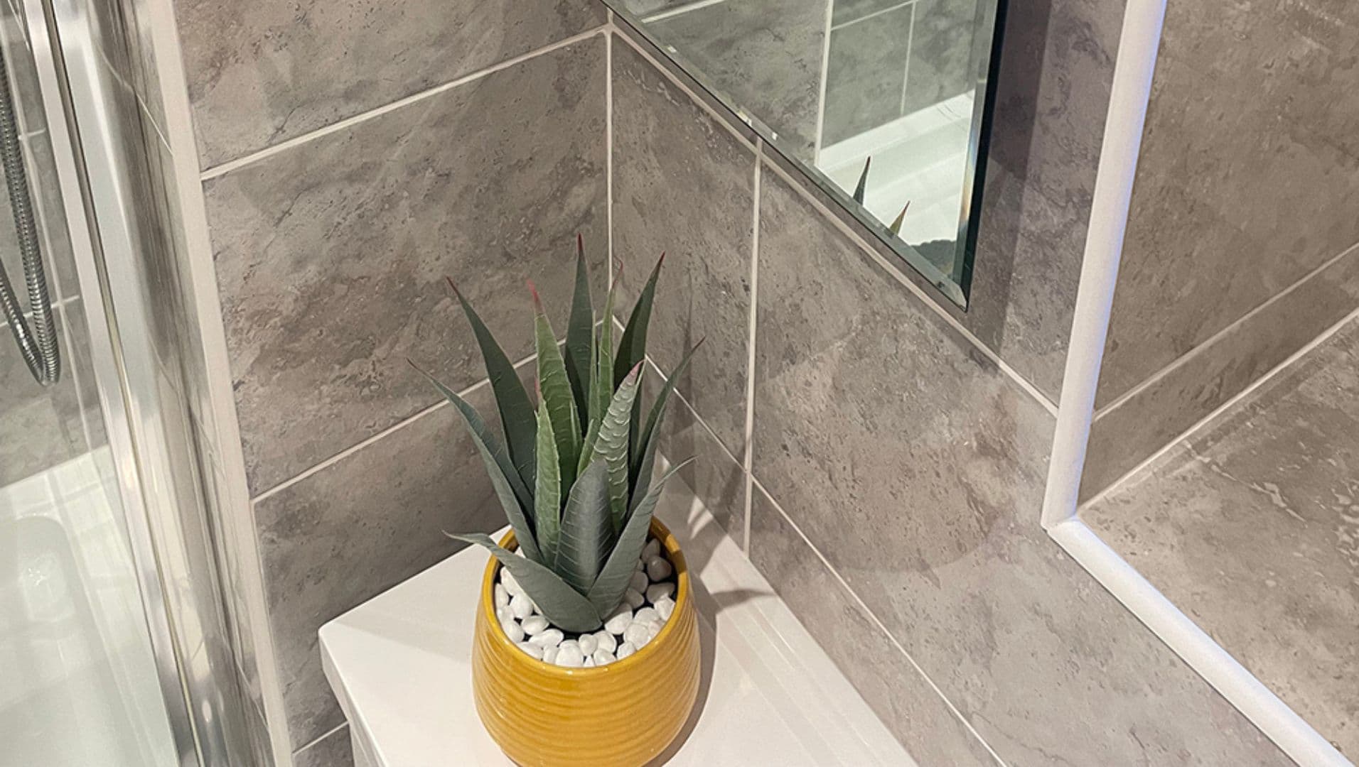 Close-up of white PVC tile trim in a modern bathroom