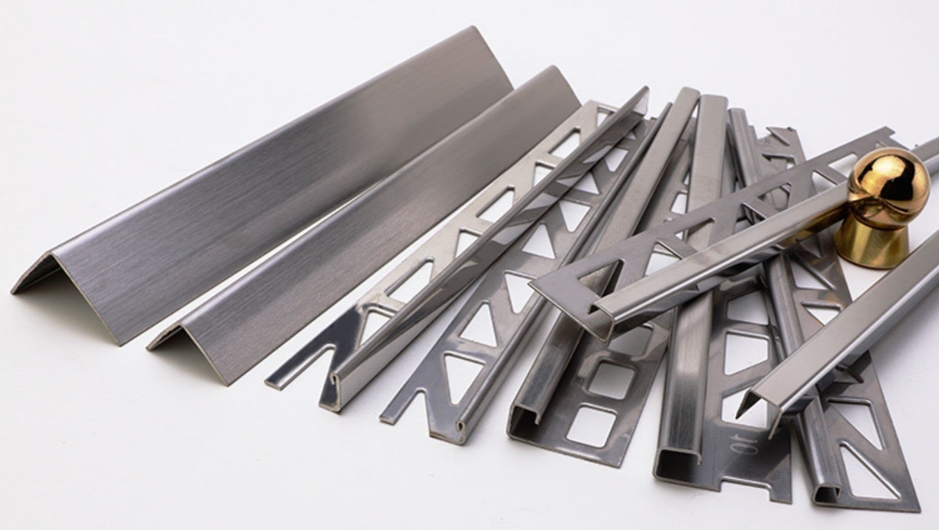 Various stainless steel tile trims arranged on a neutral backdrop