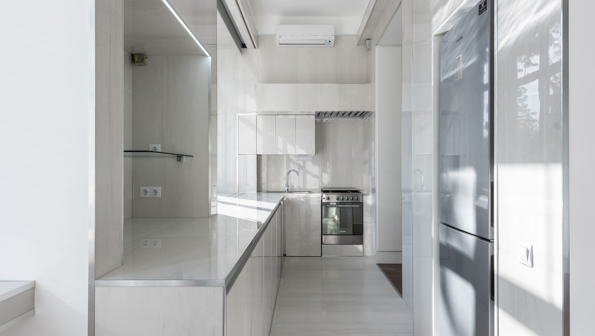 A modern kitchen with a beautifully tiled backsplash featuring metallic tile trim