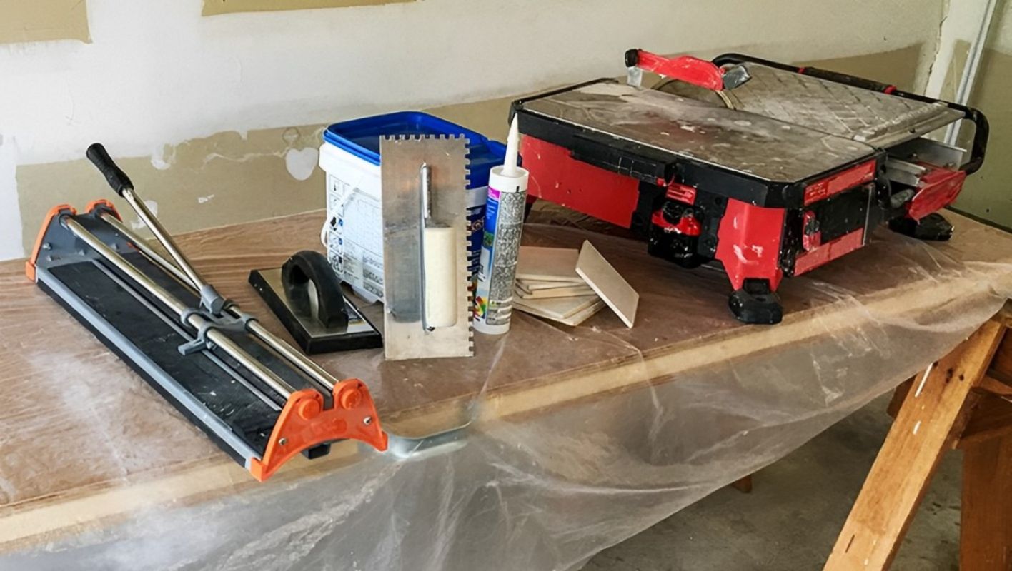 Tiling tools spread out on a wooden workbench